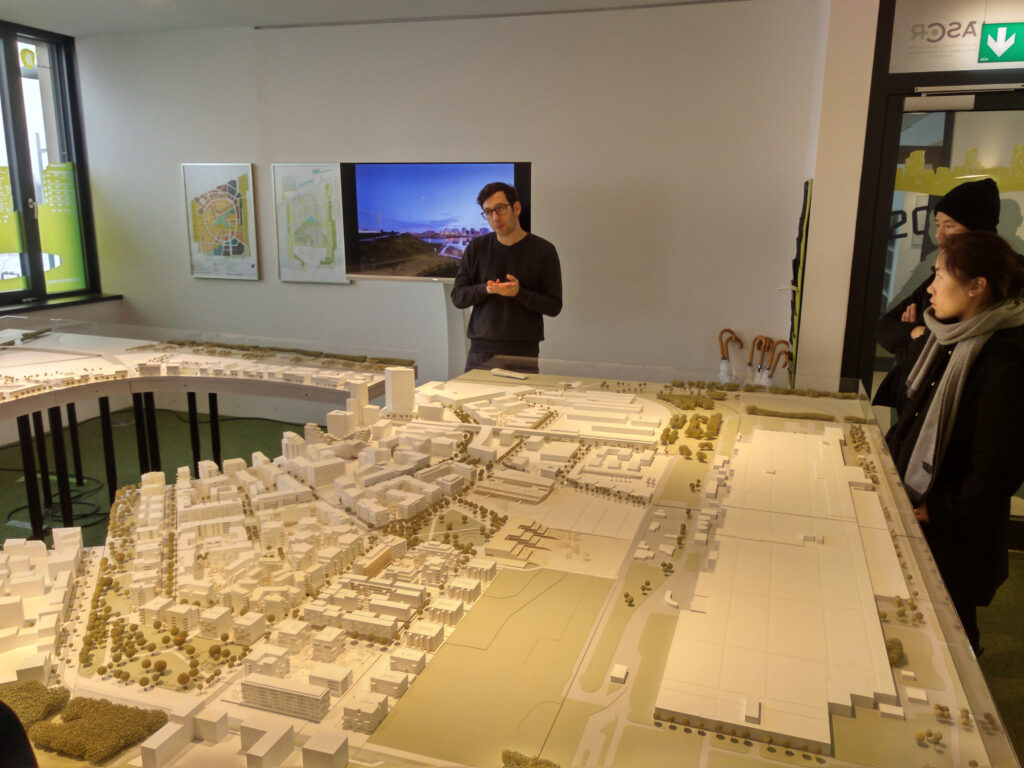 Visit of ASPERN Seestadt Development AG office, examining the model of the development area. Picture by Austrian Institute of Technology GmbH